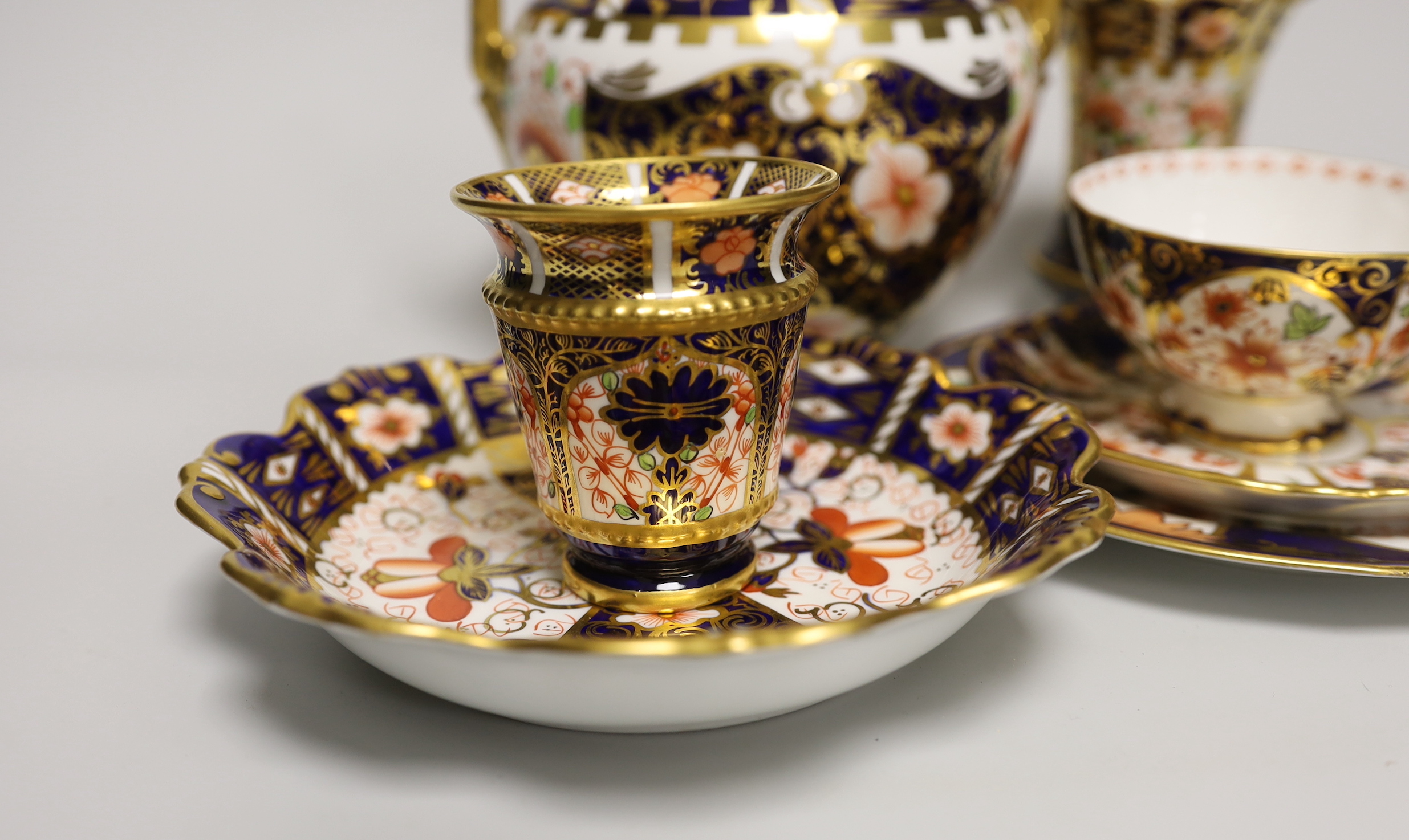 Seven pieces of Royal Crown Derby Imari porcelain including a trio and twin handled jar and cover, the largest 21cm high